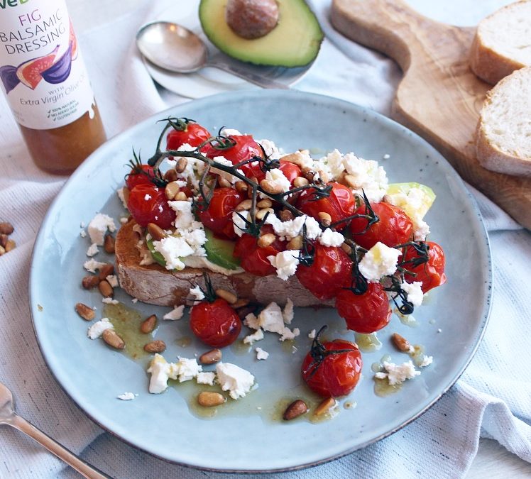 Toasted sourdough with hummus, avocado slices, baby vine tomatoes roasted in Olive Branch Fig Balsamic Dressing, feta and toasted pine nuts